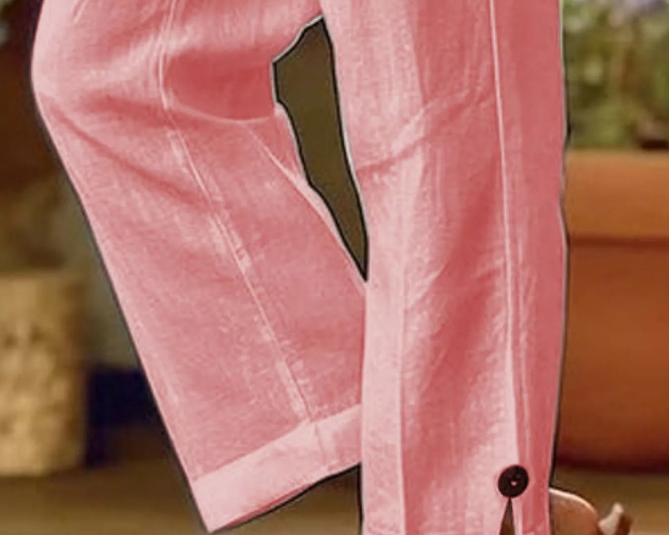 NEWYORKLISTED STYLE COLLECTION: Pink wide-leg trousers shown on a model from the knees down, featuring a split cuff with a single button and a dark olive green accent panel on the upper leg.