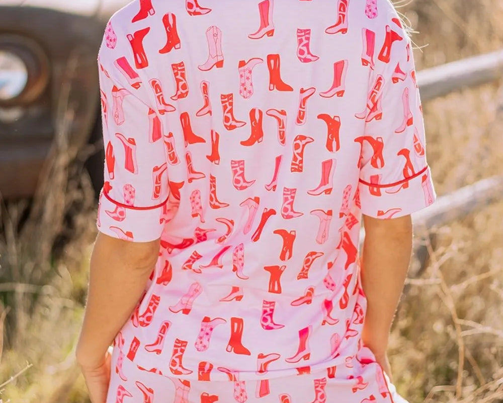 NEWYORKLISTED Intimate Apparel: Person wearing a dress with red boot pattern in a natural setting