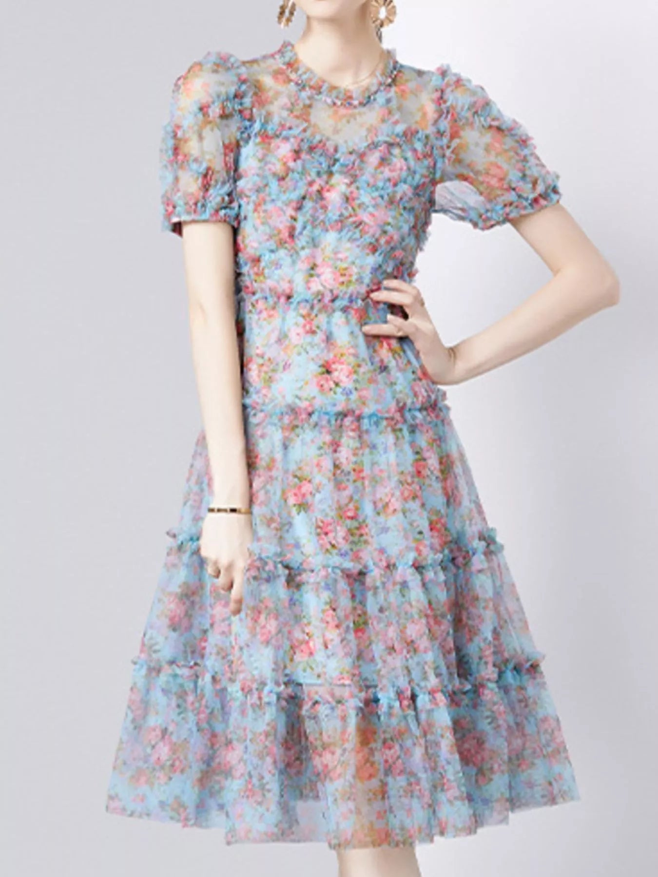 NEWYORKLISTED STYLE COLLECTION: Woman wearing a floral dress on a plain background