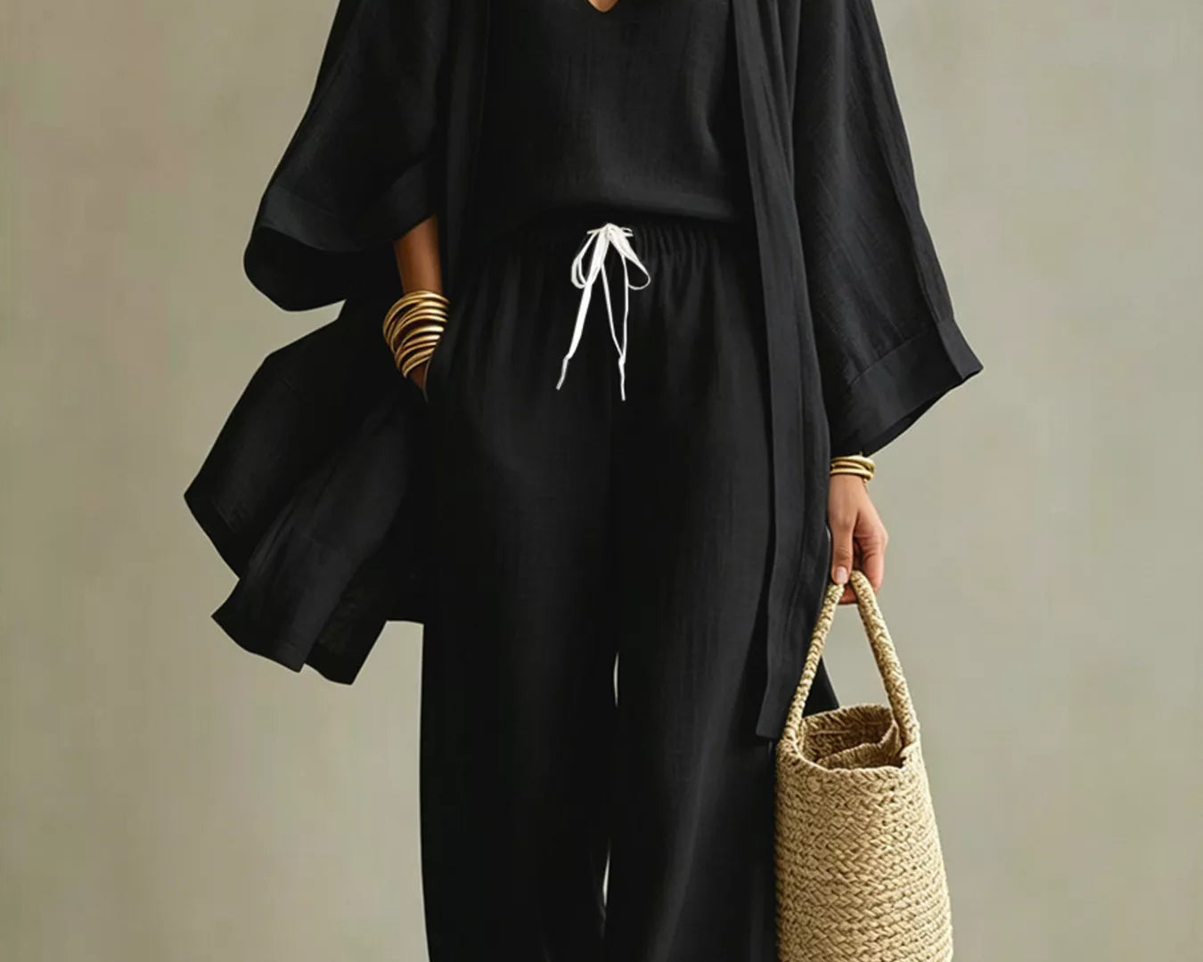 NEWYORKLISTED STYLE COLLECTION: Woman wearing a black outfit with a beige background