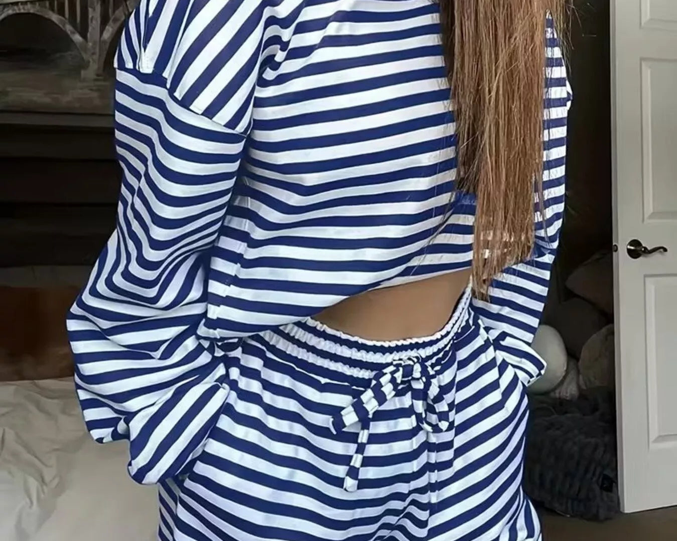 NEWYORKLISTED Comfort Collection: Person wearing a blue and white striped outfit in a room.