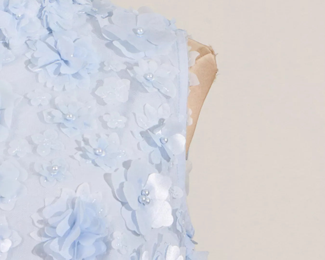 NEWYORKLISTED STYLE COLLECTION: Light blue floral dress on a mannequin against a beige background
