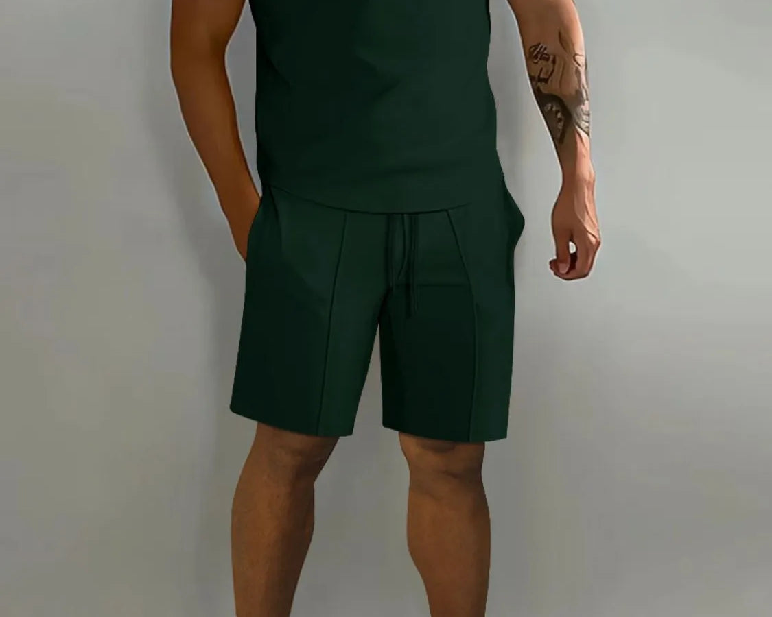 NEWYORKLISTED ATLAS MEN's COLLECTION: Person wearing a green polo shirt and shorts set with white sneakers on a gray background
