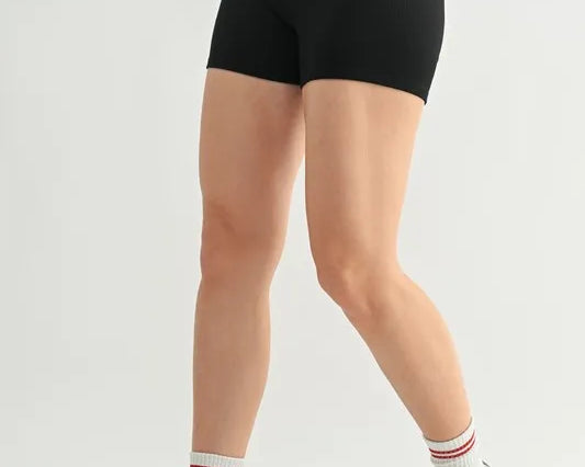 NEWYORKLISTED ACTIVEWEAR: Person wearing black high-waisted shorts on a white background