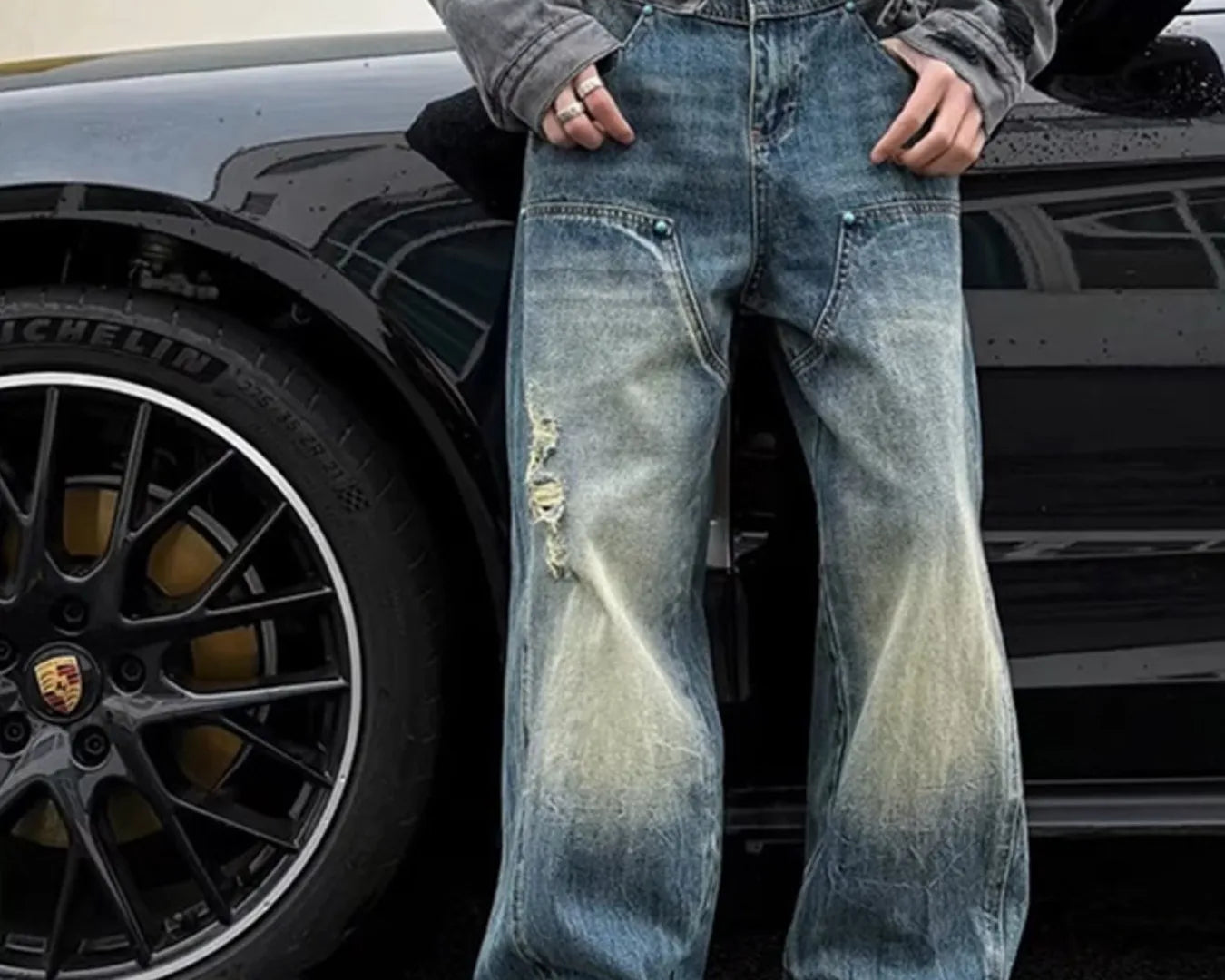 NEWYORKLISTED ATLAS MEN's COLLECTION: Person wearing distressed blue jeans standing next to a car