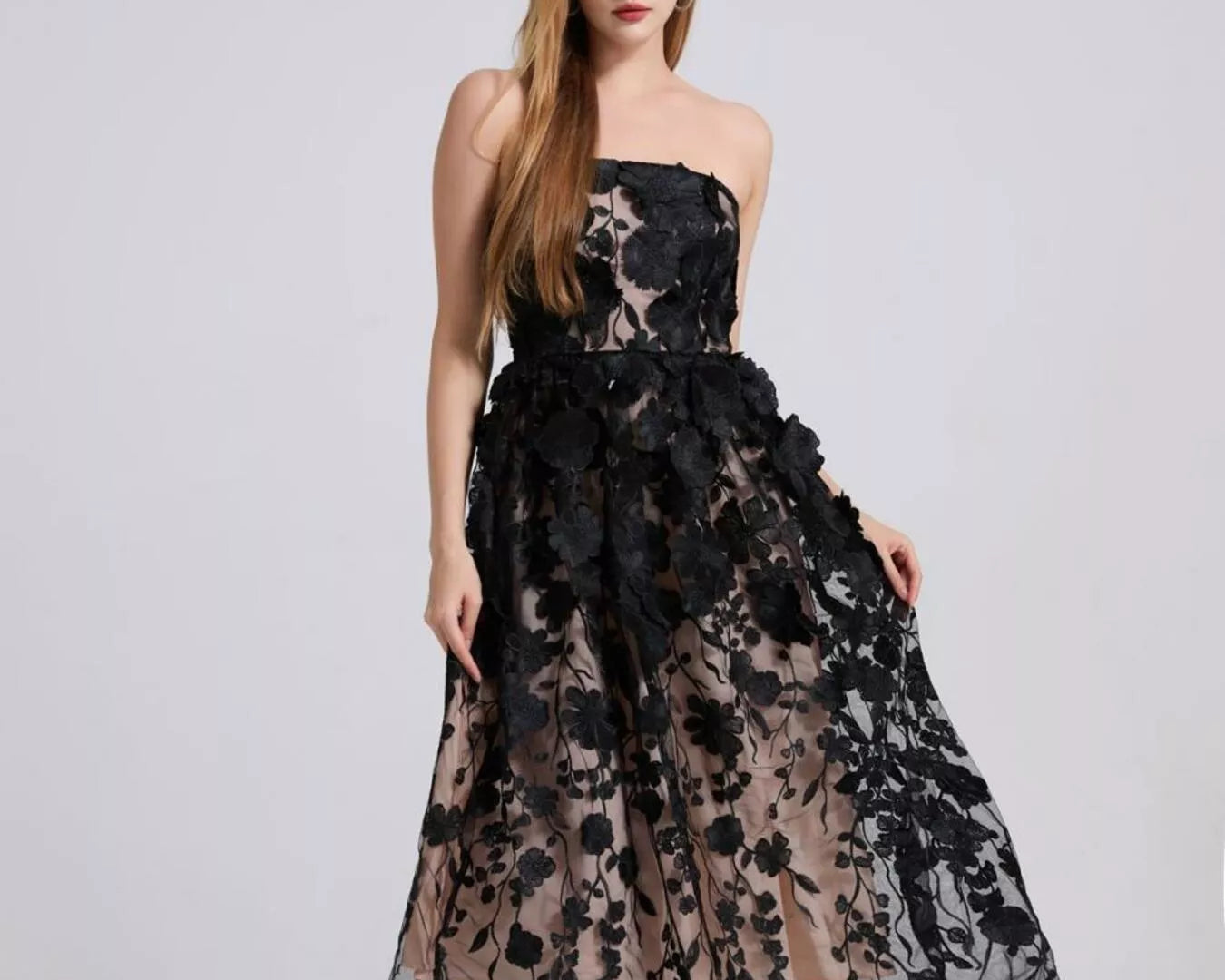 NEWYORKLISTED STYLE COLLECTION: Woman wearing a black floral lace dress on a white background