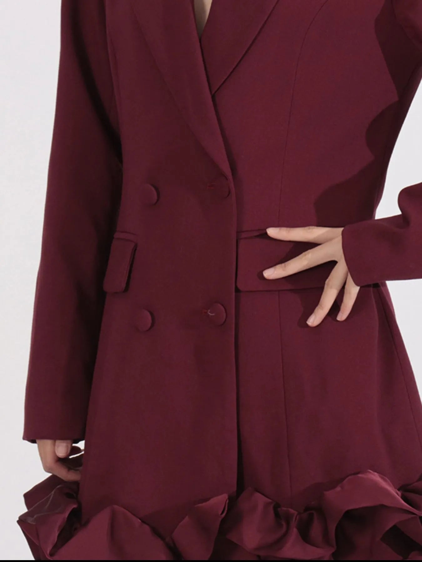 NEWYORKLISTED Runway Style: Maroon coat with ruffled details on a white background