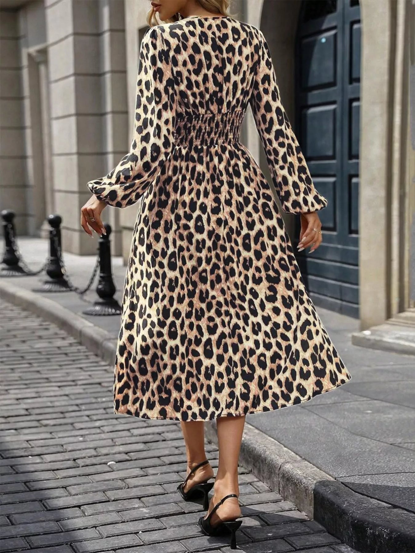 NEWYORKLISTED STYLE COLLECTION: Person wearing a leopard print dress on a city street.