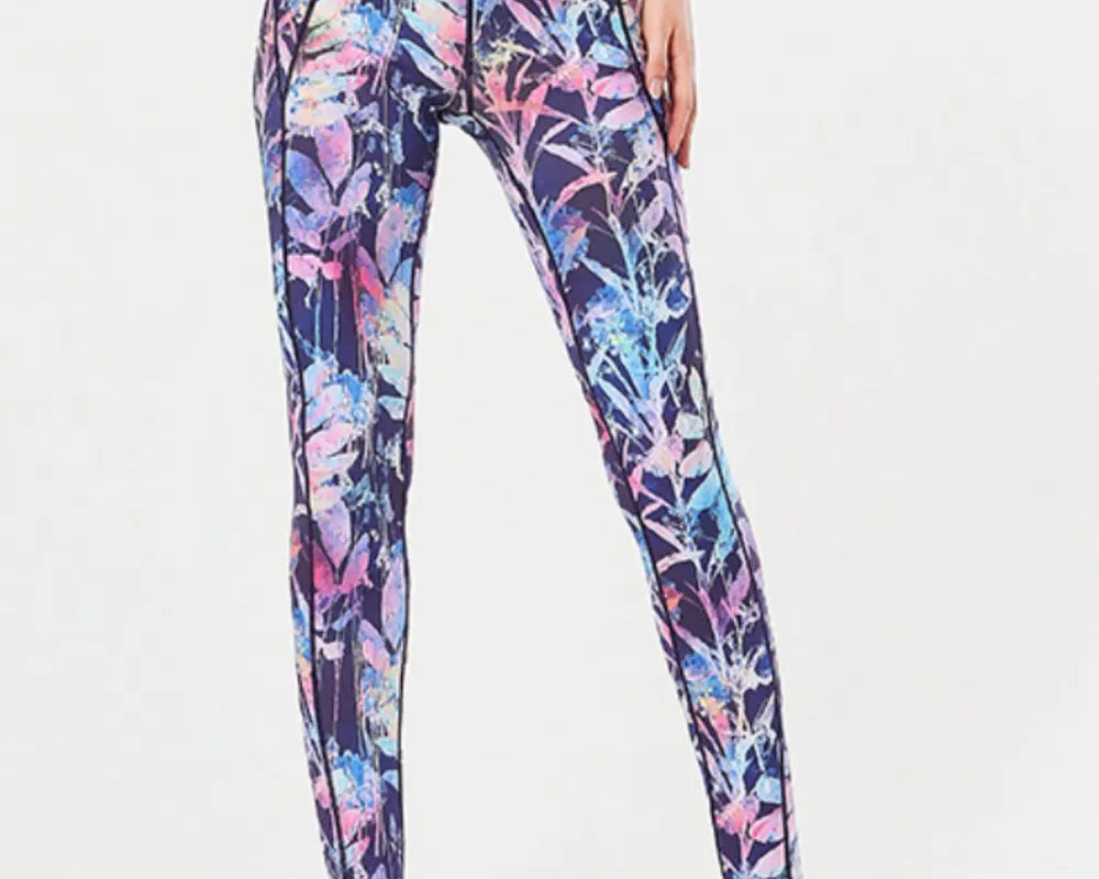 NEWYORKLISTED ACTIVEWEAR COLLECTION: Multicolored floral leggings worn by a person on a white background