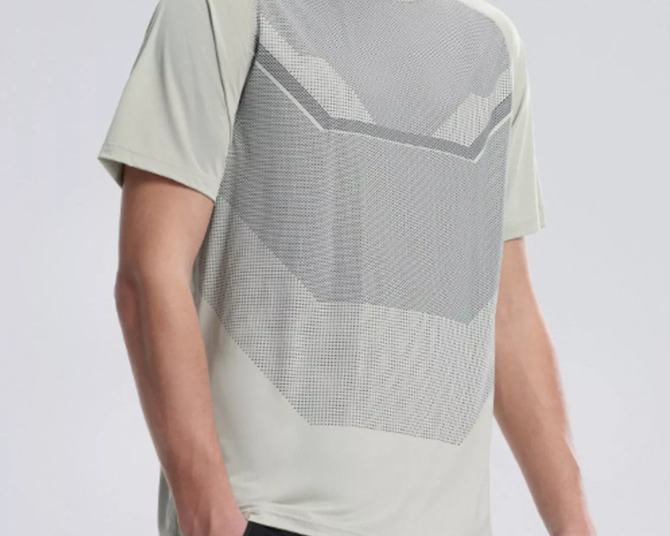 NEWYORKLISTED ATLAS MEN'S COLLECTION: Person wearing a modern, light-colored t-shirt with geometric patterns on a plain background