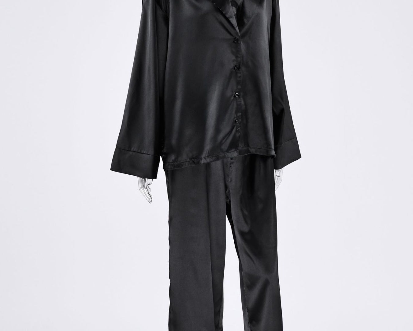 NEWYORKLISTED Intimate Apparel Collection: Black satin pajama set on a mannequin against a white background