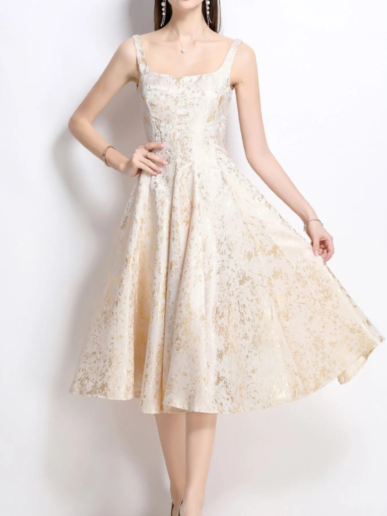 NEWYORKLISTED STYLE COLLECTION: Woman wearing a white lace dress against a plain background