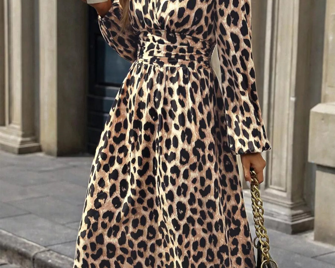 NEWYORKLISTED STYLE COLLECTION: Woman wearing a leopard print dress holding a coffee cup and a handbag.