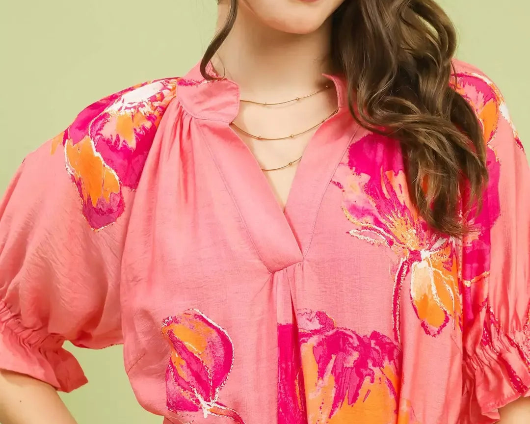 NEWYORKLISTED STYLE COLLECTION: Woman wearing a pink floral dress with a green background