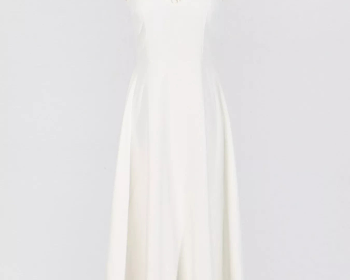 NEWYORKLISTED STYLE COLLECTION: White dress on a mannequin against a plain background