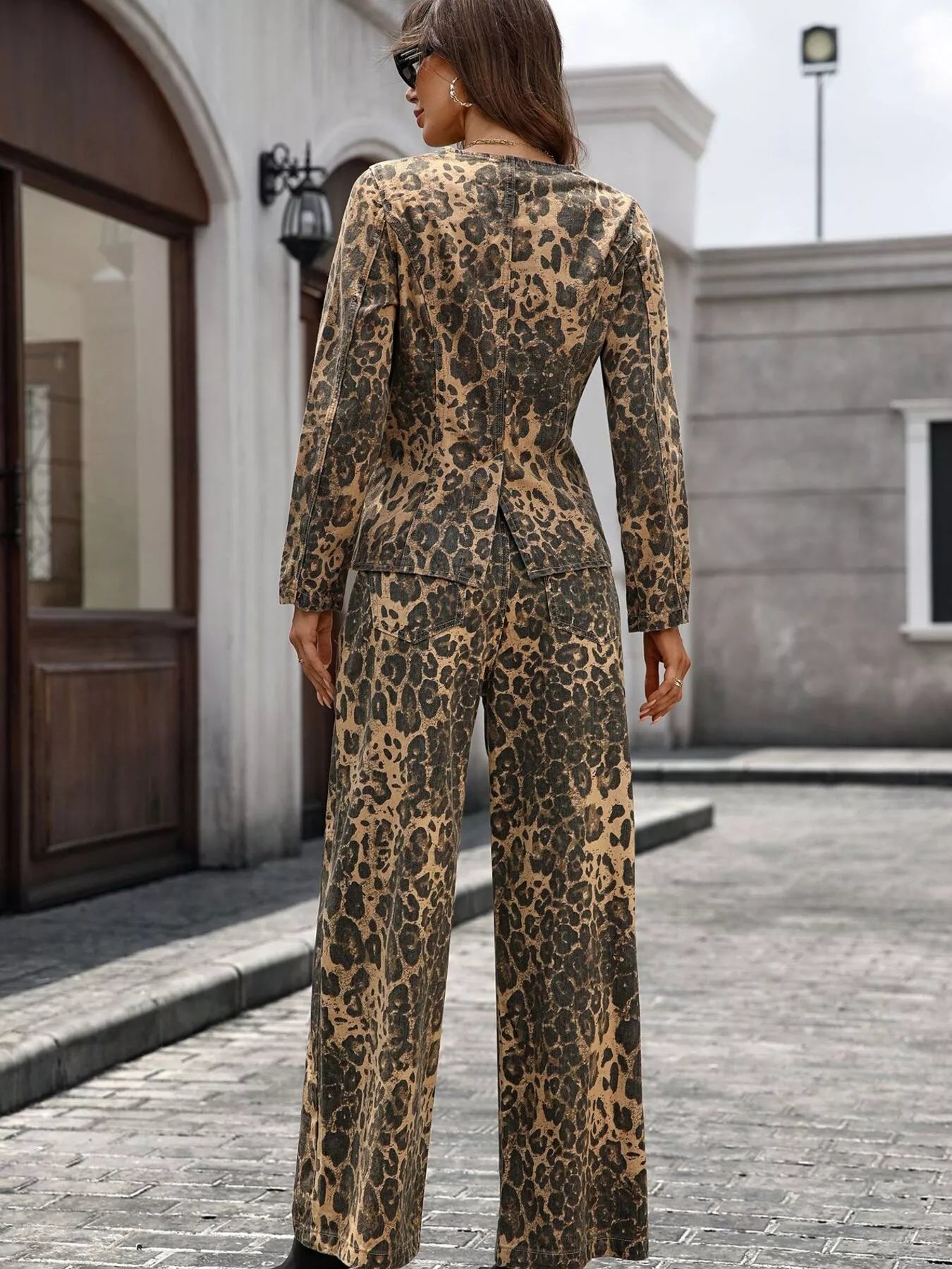 NEWYORKLISTED STYLE COLLECTION: Person wearing a leopard print outfit standing on a street.