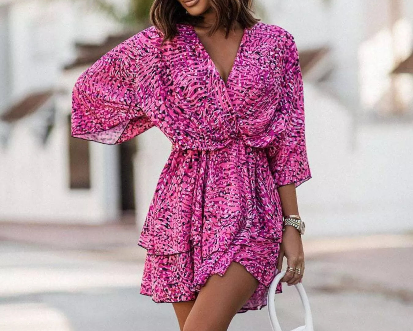 NEWYORKLISTED STYLE COLLECTION: Woman wearing a pink floral dress with a blurred background