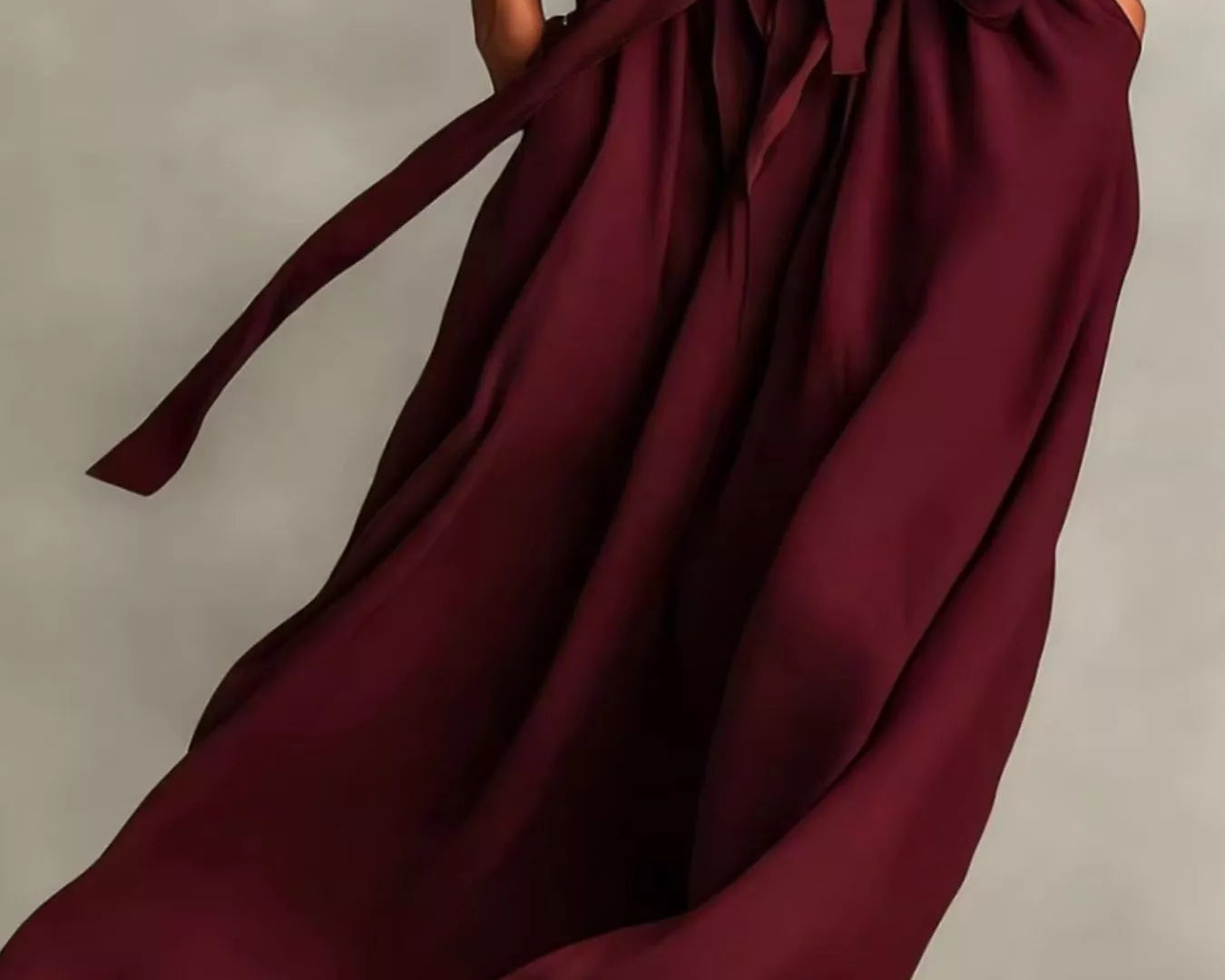 NEWYORKLISTED STYLE COLLECTION: Maroon wrap dress with a belt on a neutral background