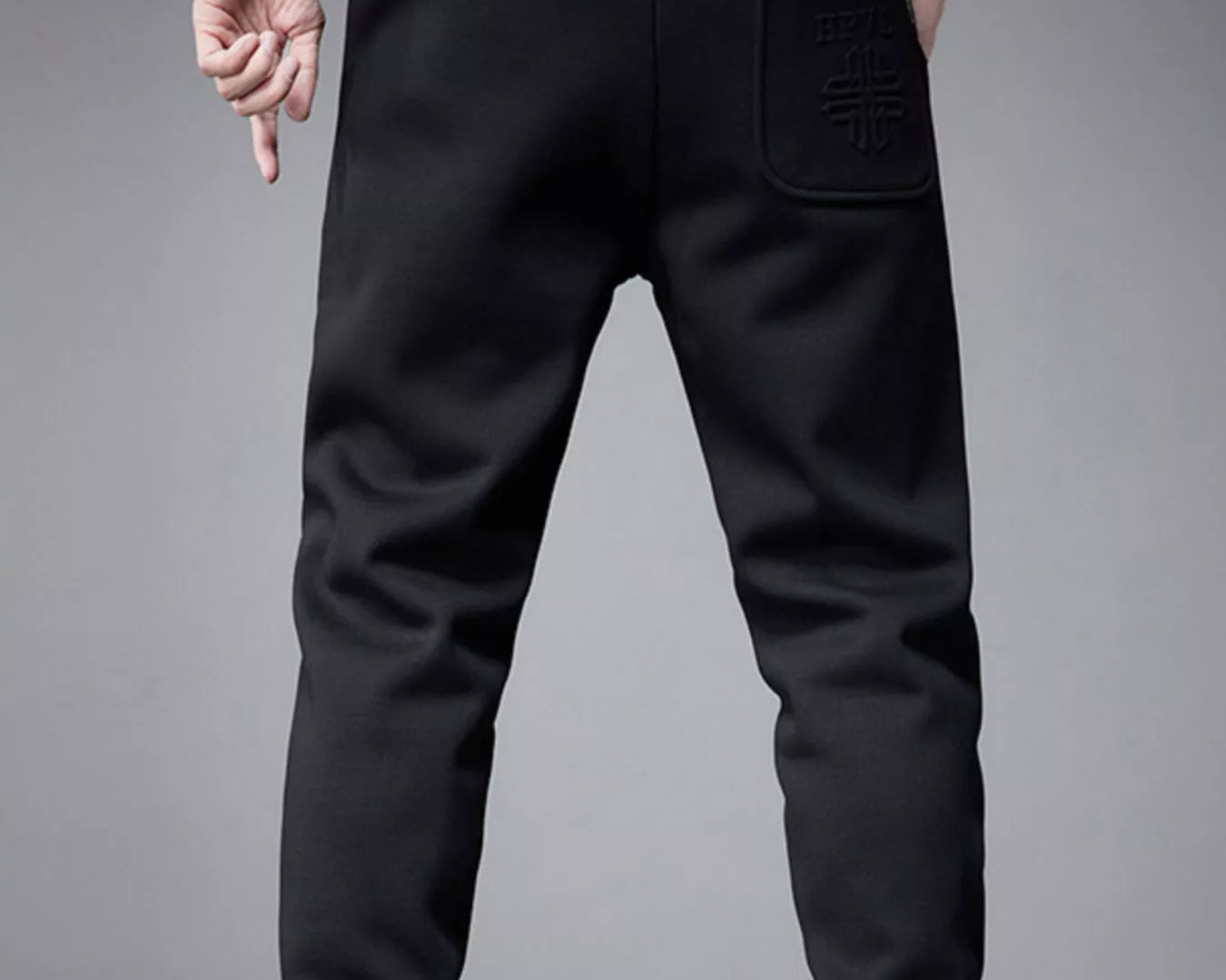 NEWYORKLISTED ATLAS MEN's COLLECTION: Black jogger pants worn by a person on a gray background