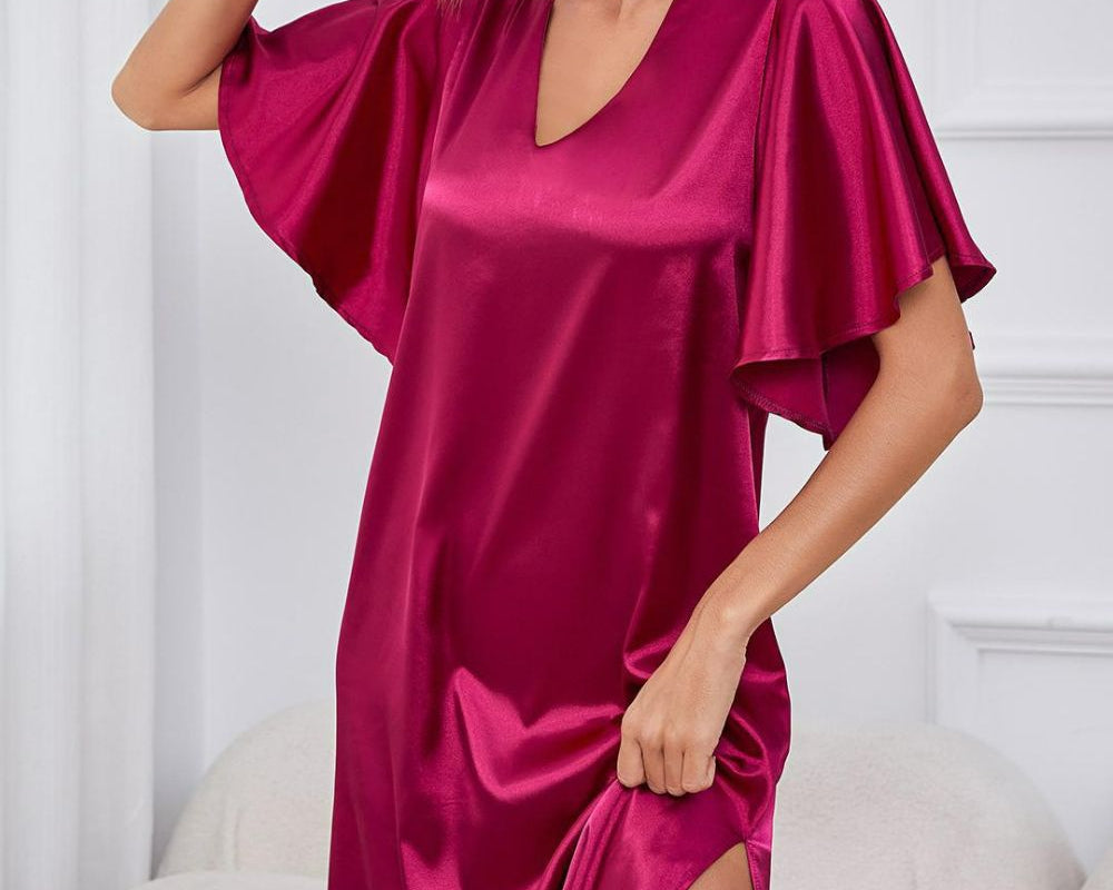 NEWYORKLISTED Intimate Apparel: Woman wearing a pink satin nightgown sitting on a white couch.