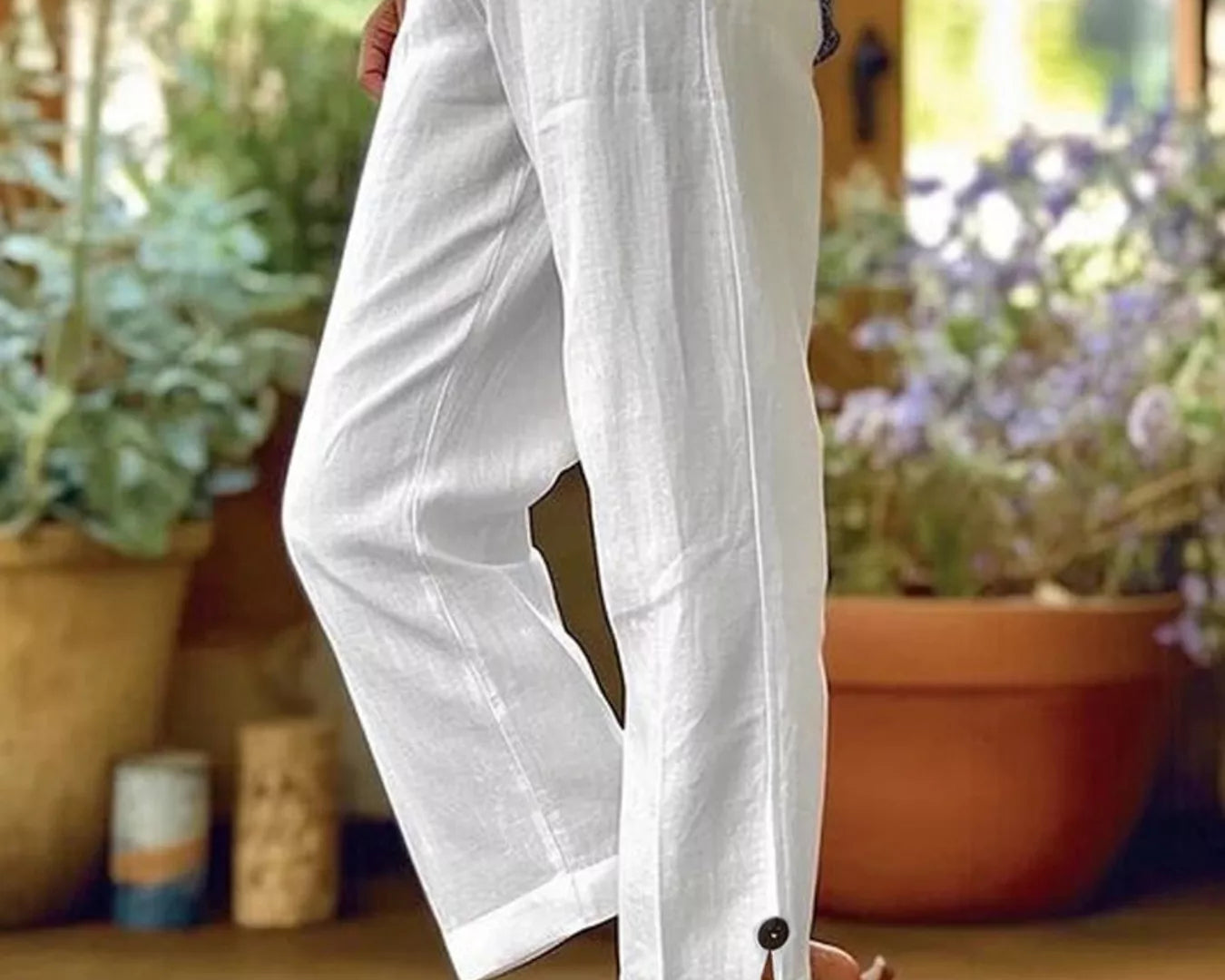 NEWYORKLISTED STYLE COLLECTION: Person wearing white pants with a blurred indoor background