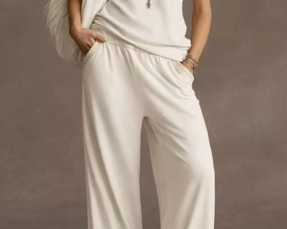 NEWYORKLISTED STYLE COLLECTION: Woman wearing a white outfit with a plain background