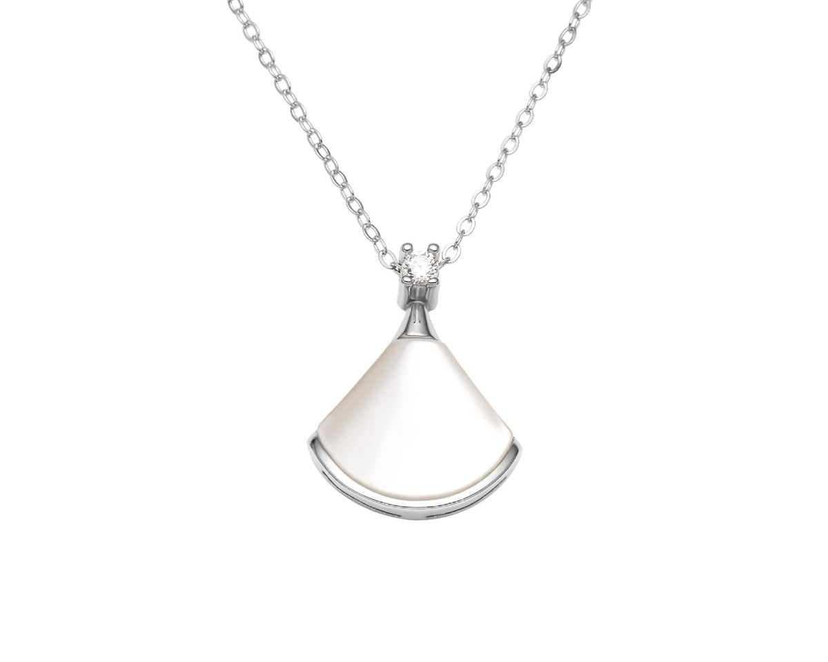 NYLD Glamour By NEWYORKLISTED: Silver necklace with a teardrop-shaped pendant on a white background
