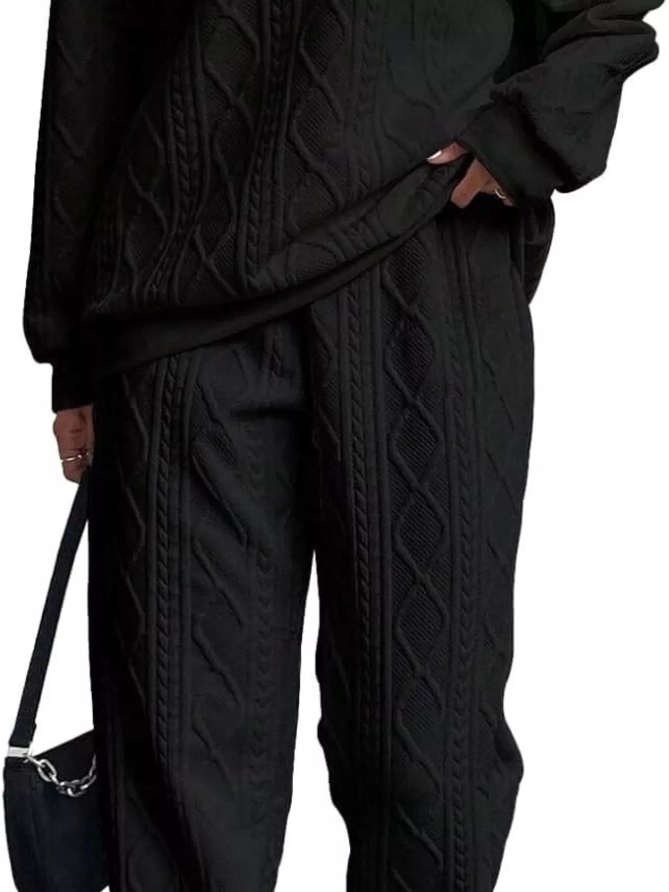 NEWYORKLISTED COMFORT COLLECTION: Person wearing a black cable knit outfit with a handbag on a white background