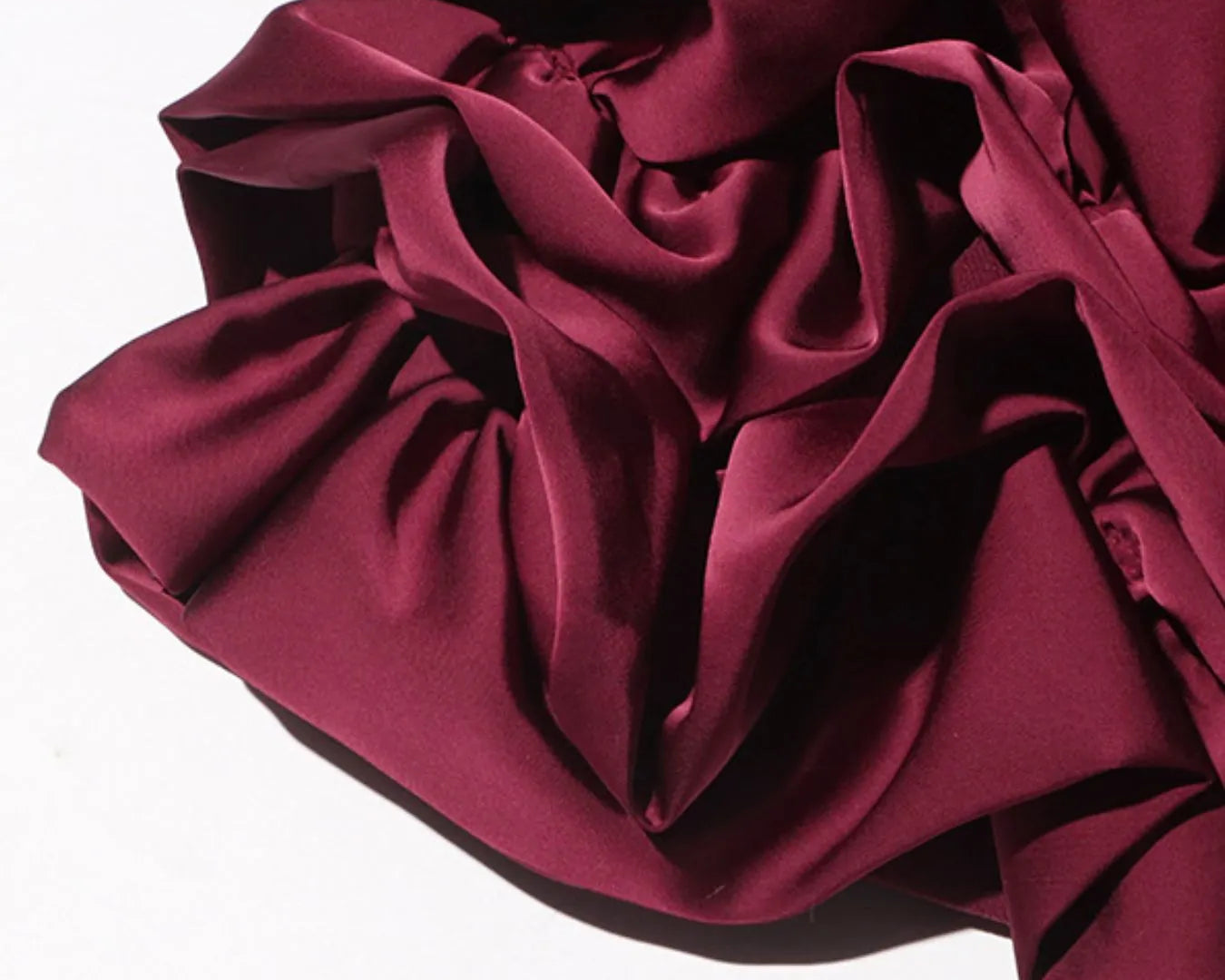 NEWYORKLISTED Runway Style: Close-up of a burgundy ruffled fabric on a white background