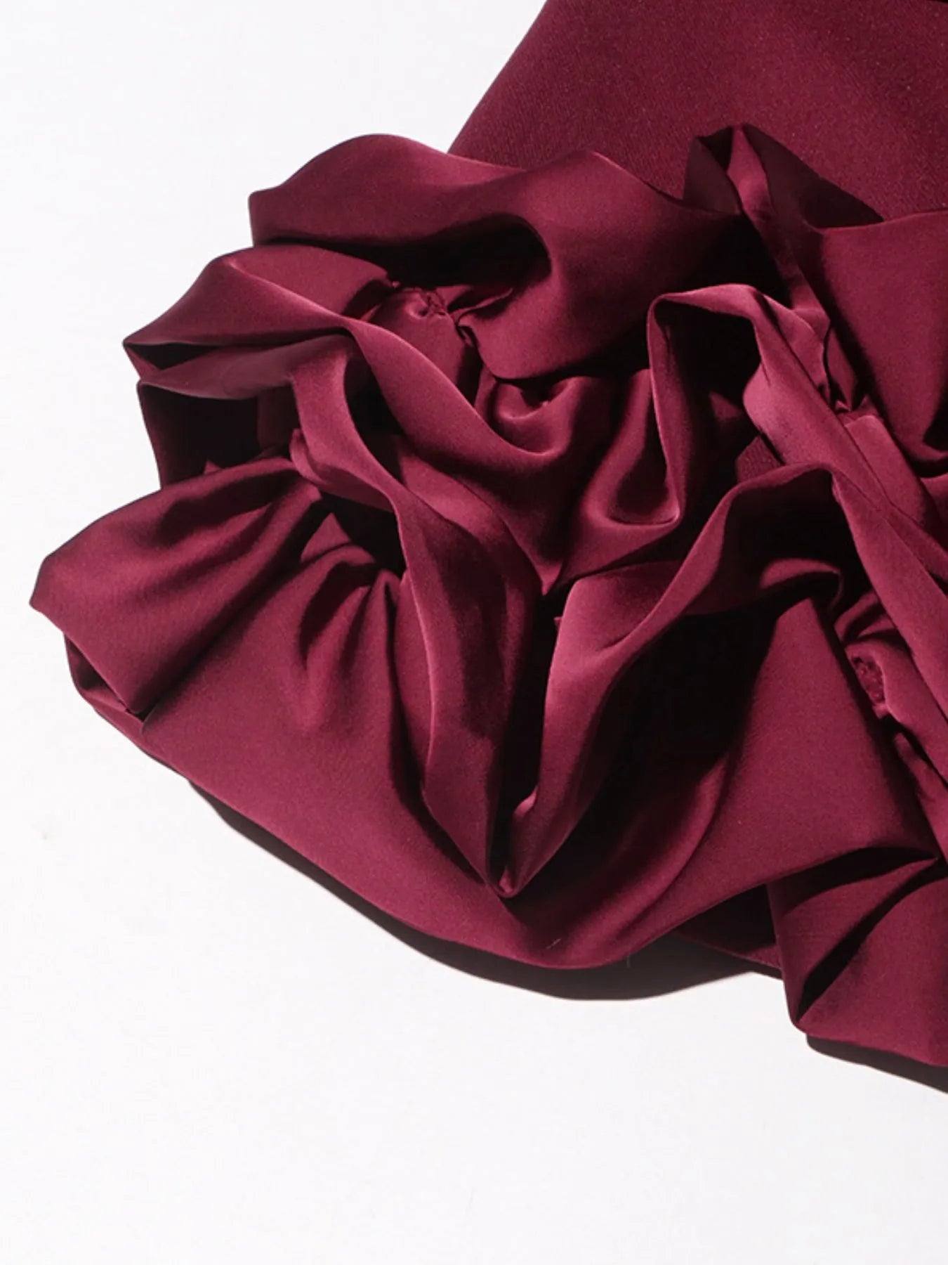 NEWYORKLISTED Runway Style: Close-up of a burgundy ruffled fabric on a white background