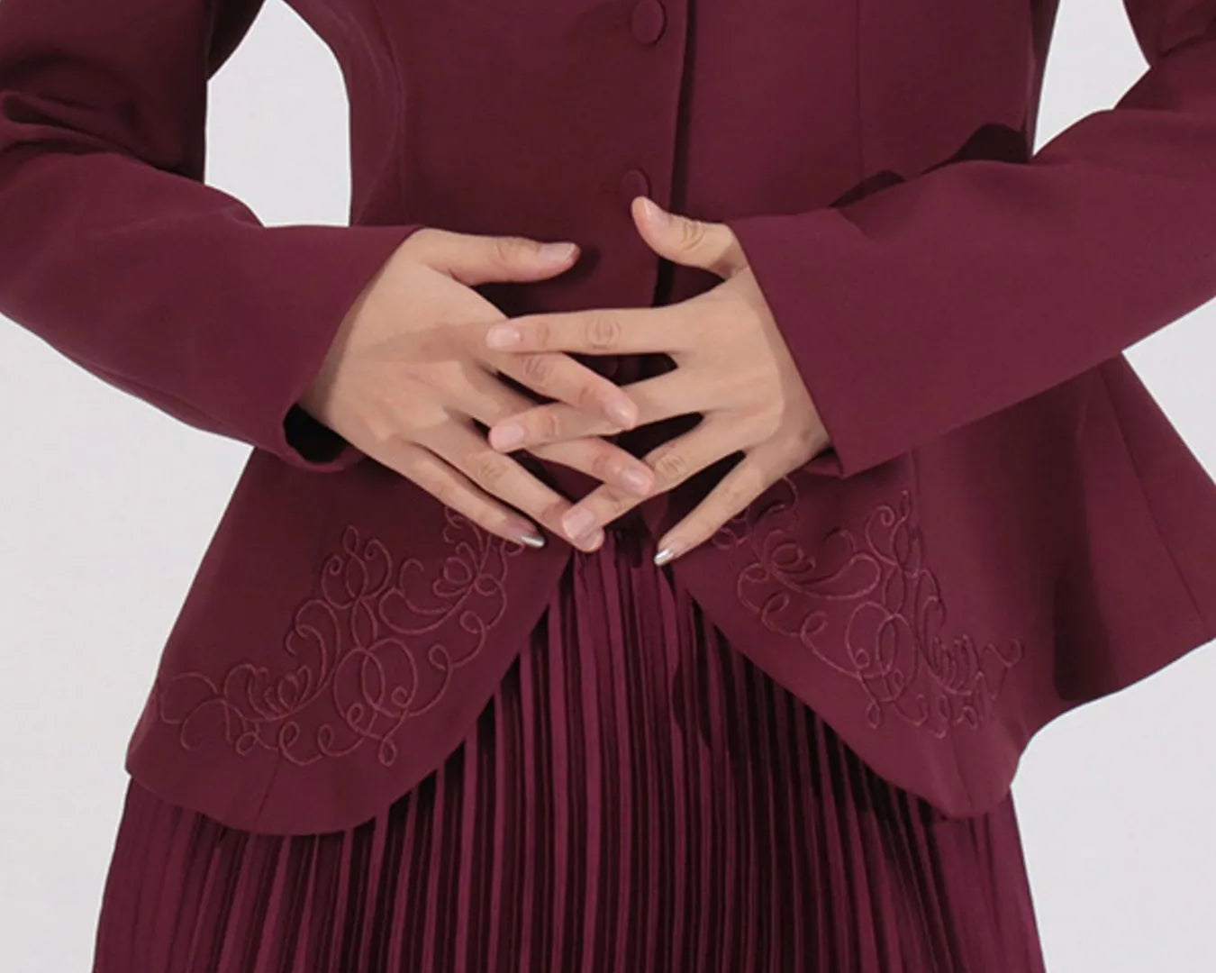 NEWYORKLISTED STYLE COLLECTION: Maroon dress with intricate detailing on a white background