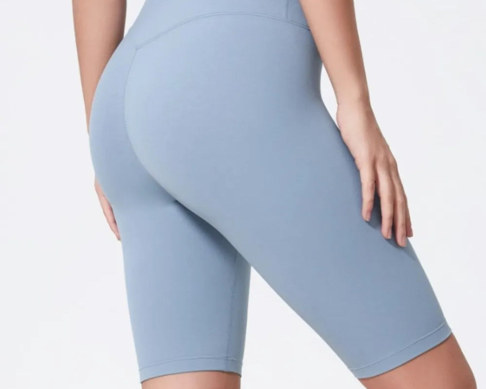 Light blue athletic shorts worn by a person on a white background