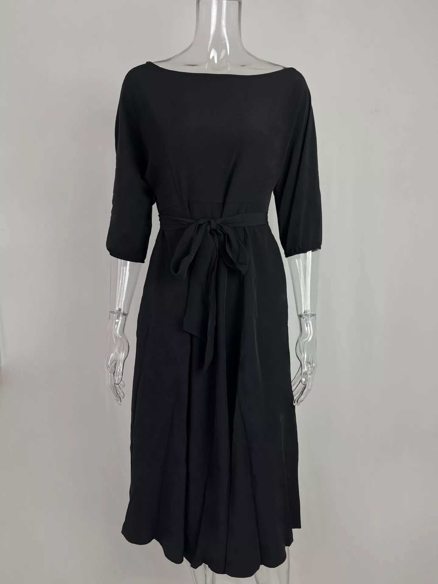 NEWYORKLISTED STYLE COLLECTION: Black dress on a mannequin against a white background