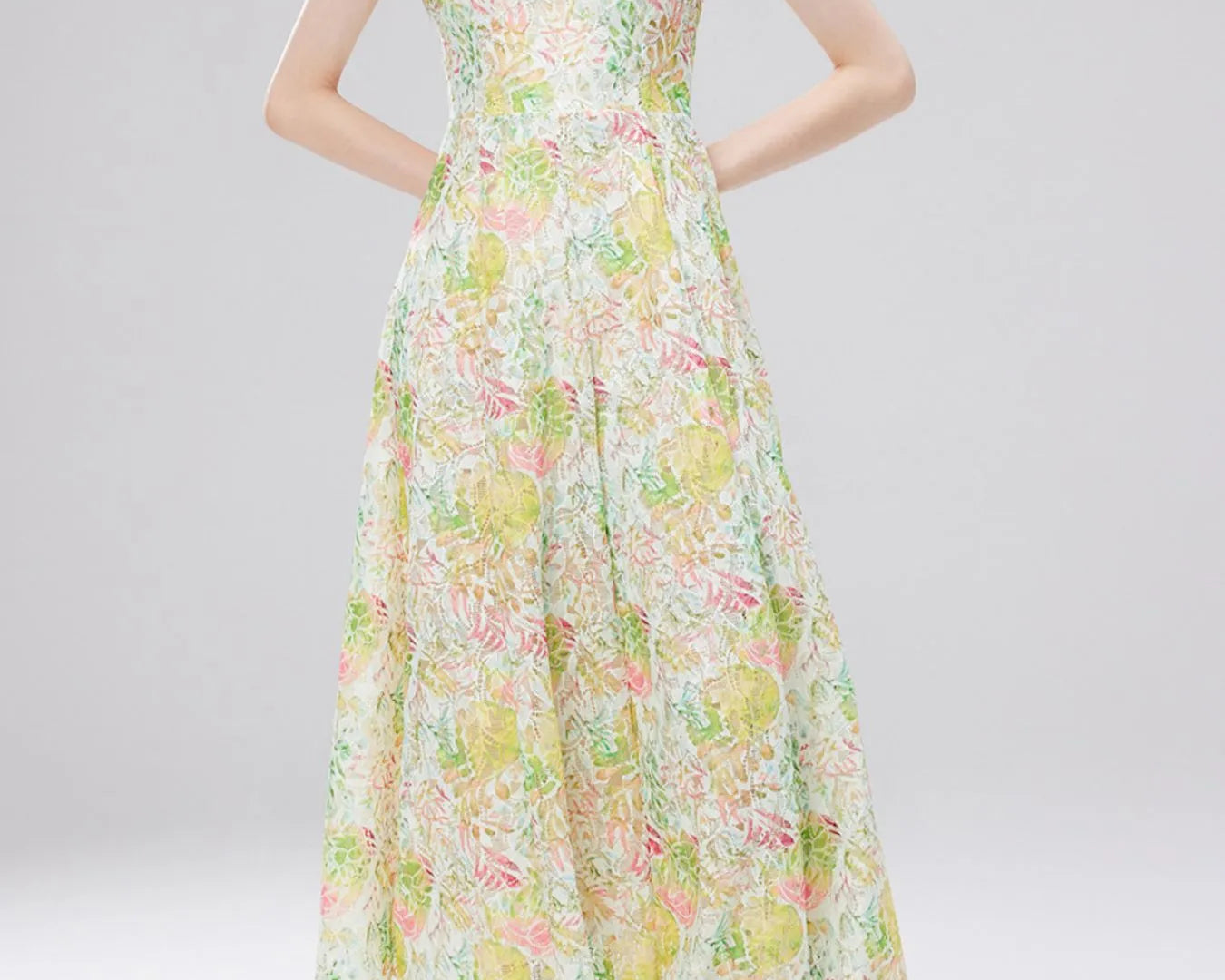 NEWYORKLISTED STYLE COLLECTION: Woman wearing a floral dress on a light gray background