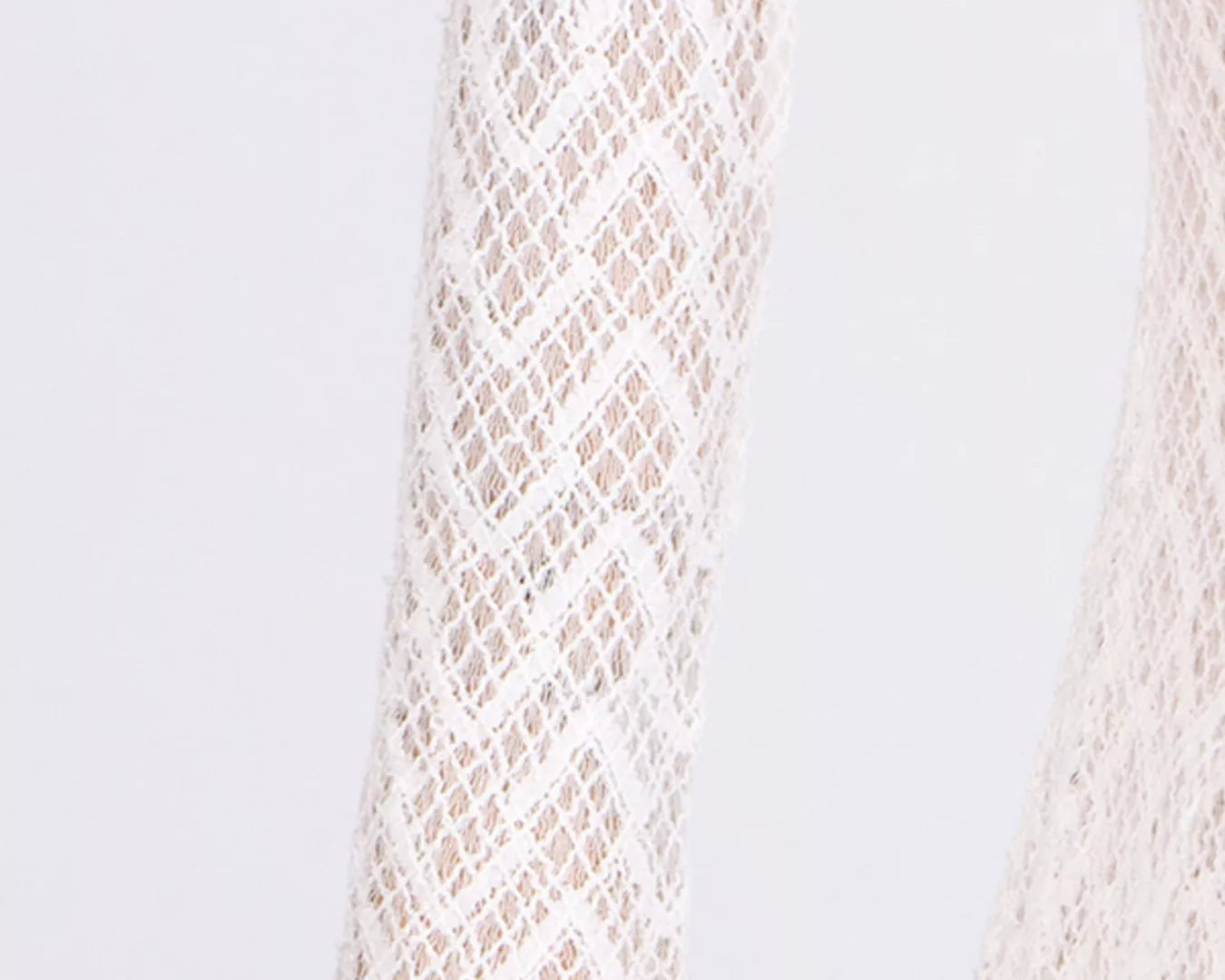 Close-up of a textured beige fabric on a light gray background