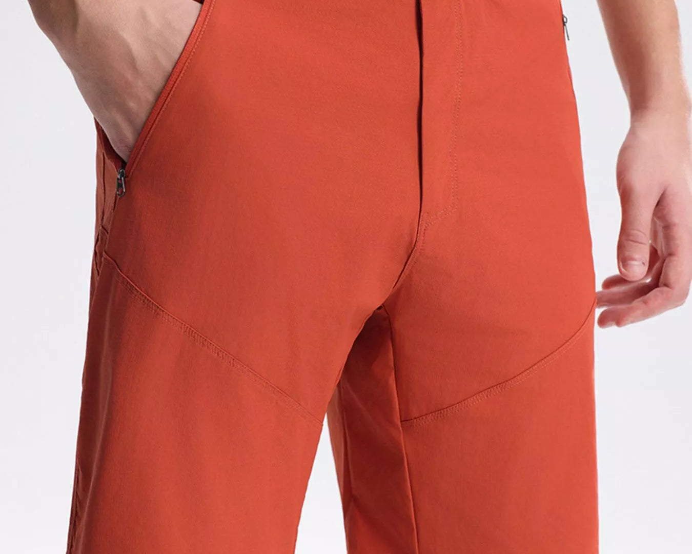 NEWYORKLISTED ATLAS MEN's COLLECTION: Orange shorts worn by a person on a white background