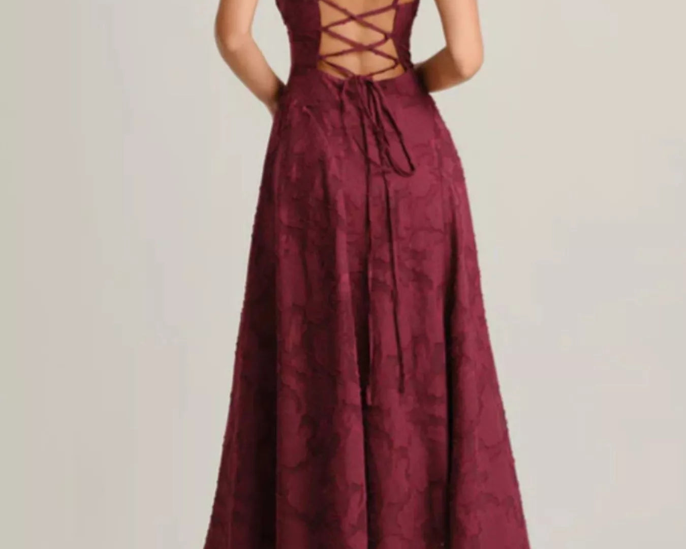 NEWYORKLISTED STYLE COLLECTION: Burgundy lace dress with criss-cross back on a plain background