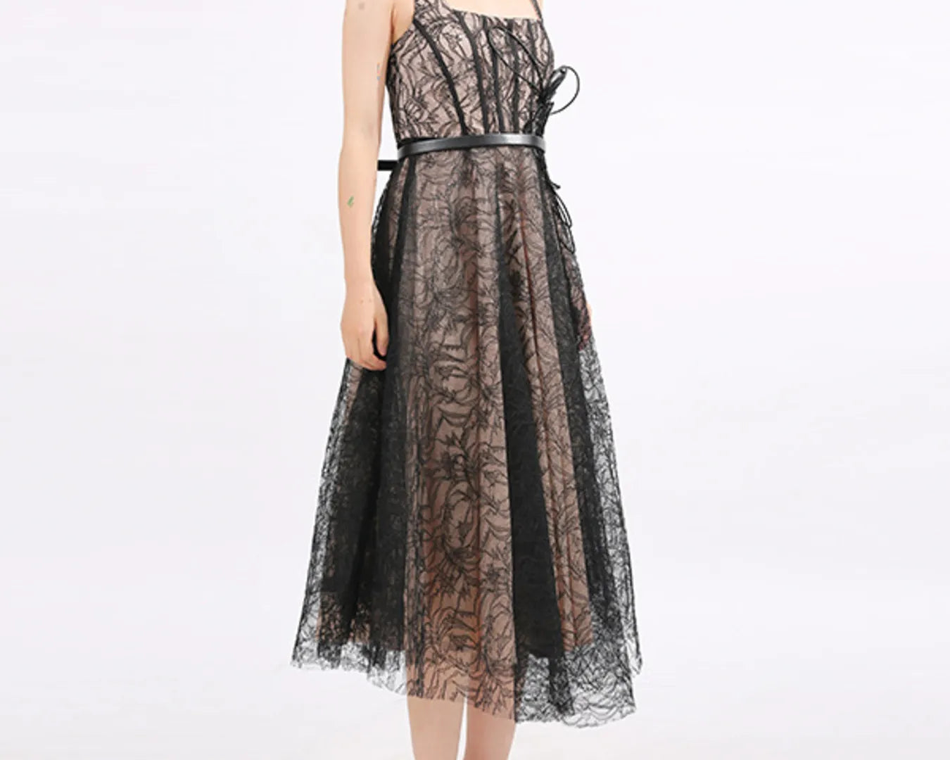 NEWYORKLISTED RUNWAY STYLE: Black lace dress worn by a person on a white background