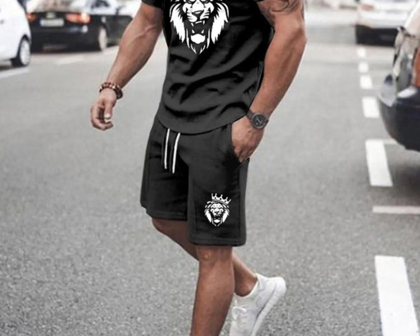 NEWYORKLISTED ATLAS MEN's COLLECTION: Man wearing a black t-shirt and shorts with a lion graphic on a street.