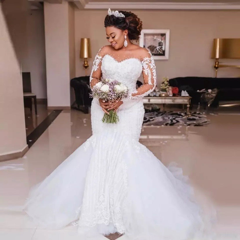 Vintage long sleeve lace ball gown wedding dress with sterling silver-toned embroidery, available in sizes 2–26W from NEWYORKLISTED Elegant Bride Collection.