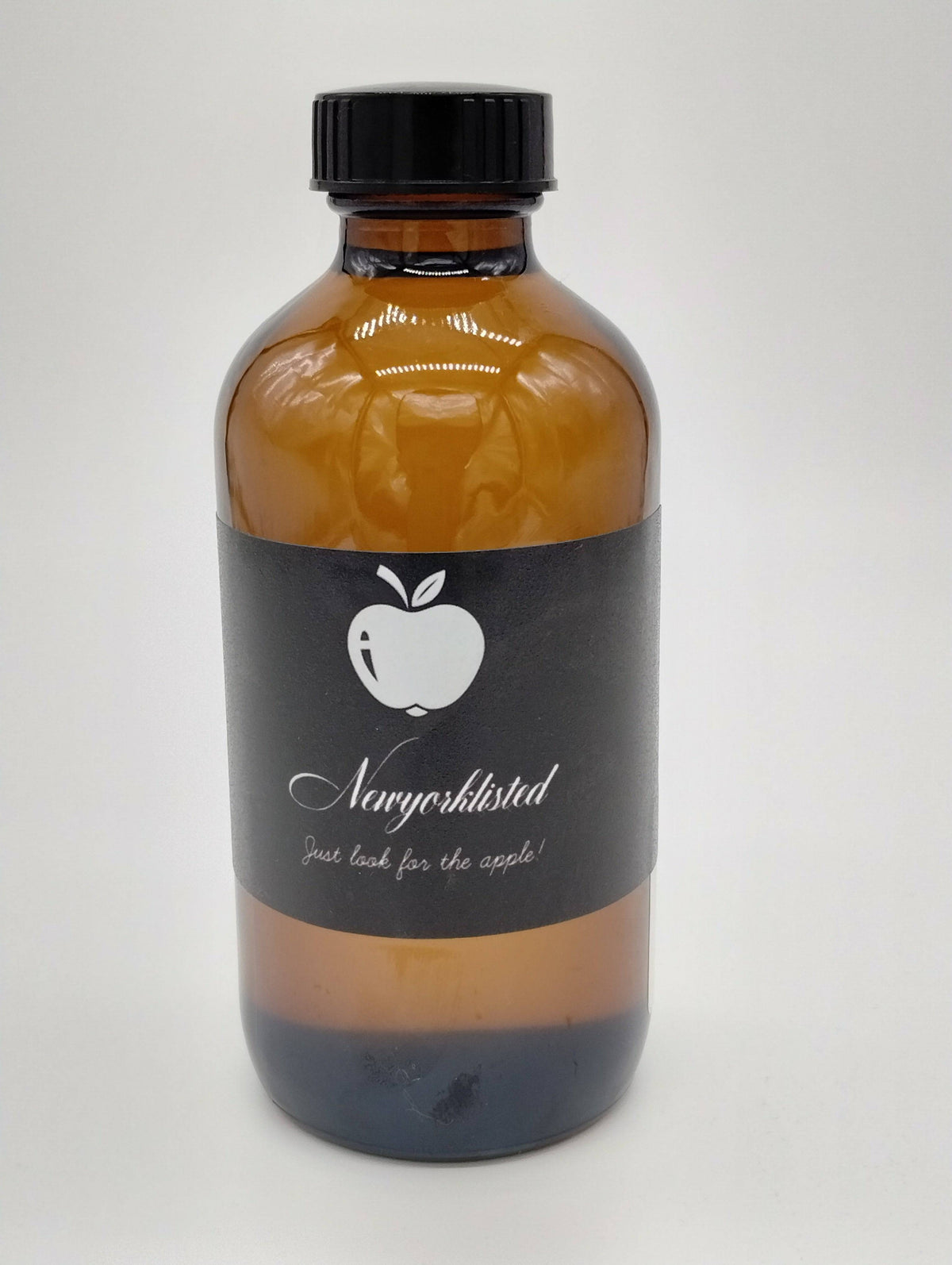 NEWYORKLISTED Organic Jamaican Black Castor Oil 8 oz amber glass bottle with front label and UPC, cold-pressed natural oil for hair growth and skin hydration.