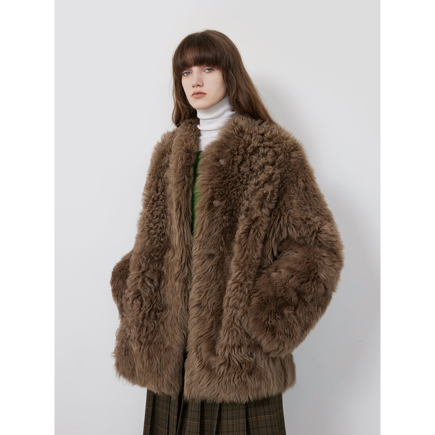 NEWYORKLISTED STYLE COLLECTION: Person wearing a brown fur coat on a white background
