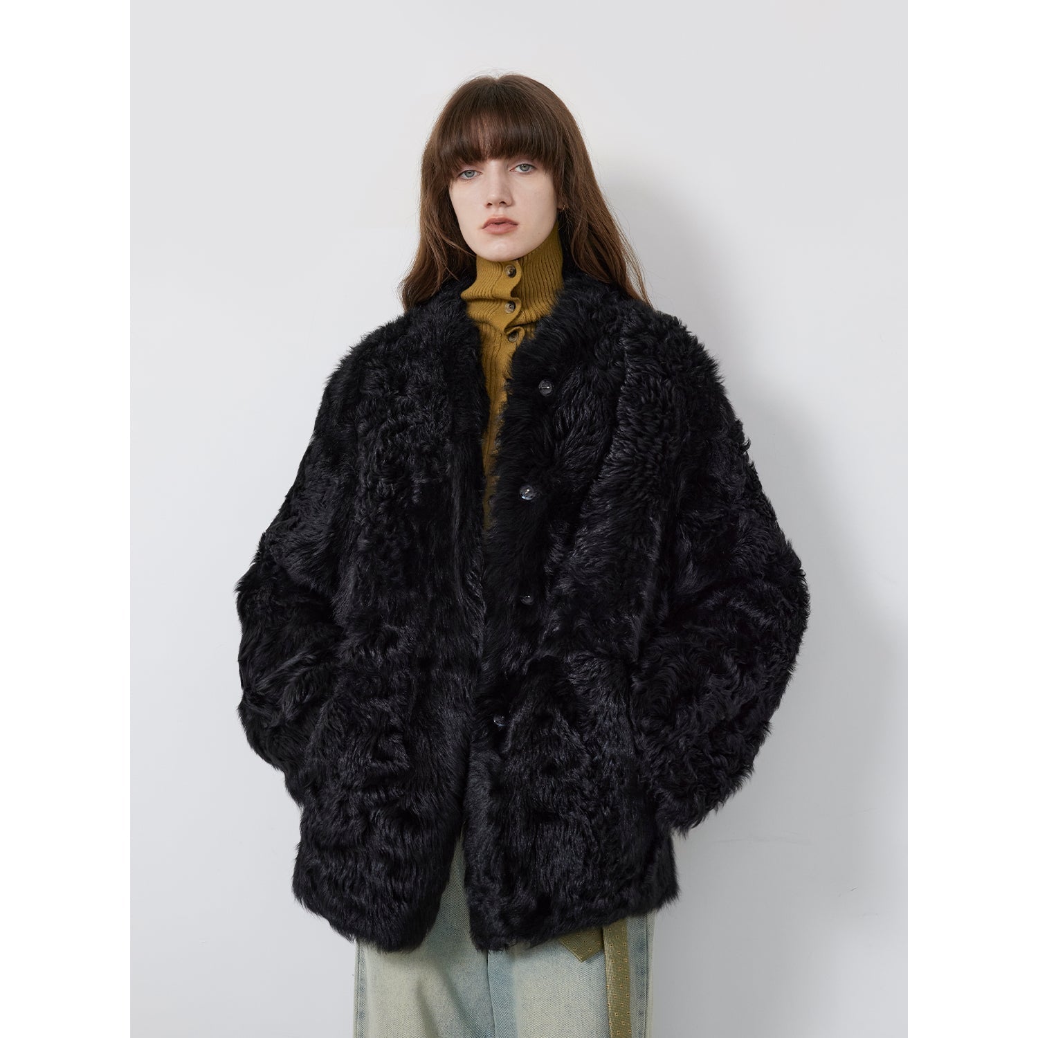 NEWYORKLSITED STYLE COLLECTION: Person wearing a black fluffy coat against a white background