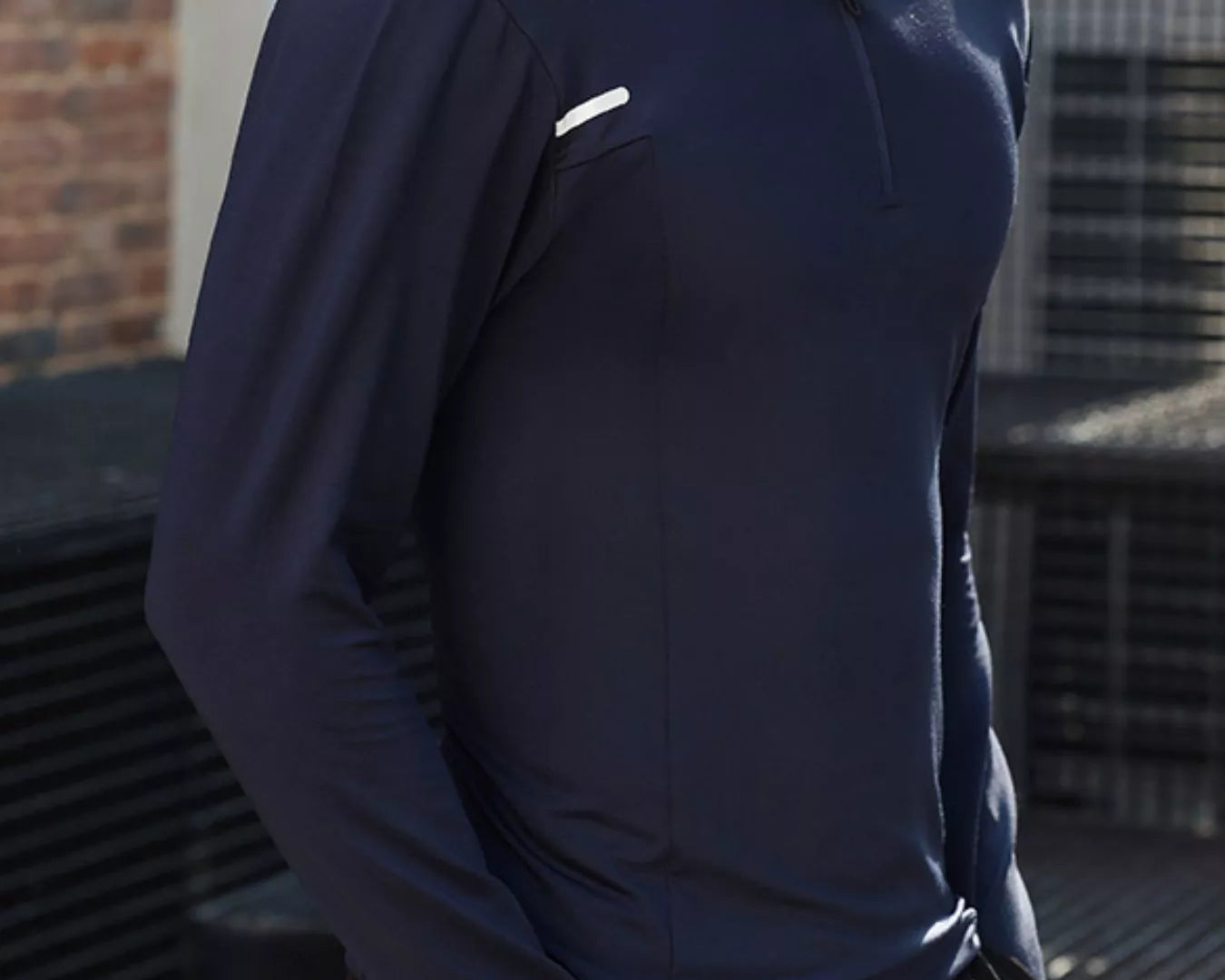 NEWYORKLISTED ATLAS MEN'S COLLECTION: Person wearing a navy blue long-sleeve shirt with a white pocket square.