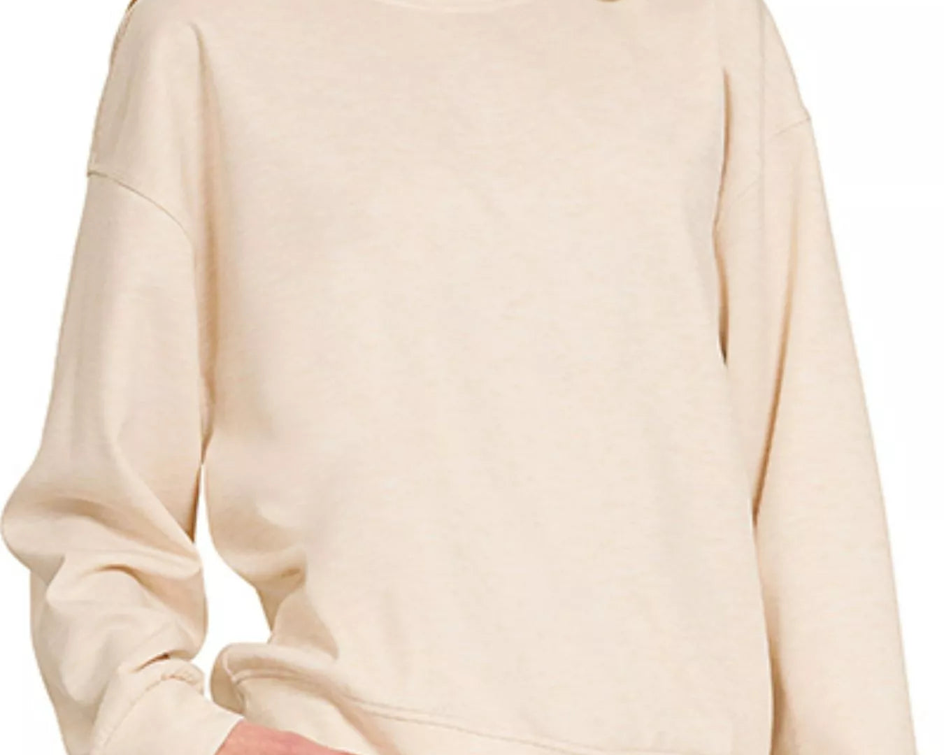 NEWYORKLISTED STYLE COLLECTION: Beige sweatshirt worn by a person on a white background