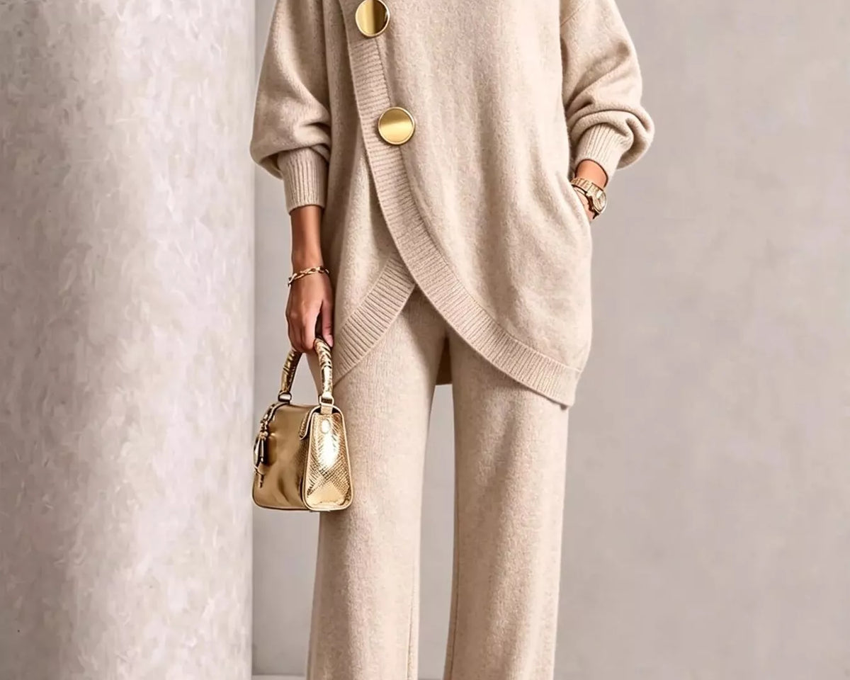 NEWYORKLISTED STYLE COLLECTION: A woman models a beige knit turtleneck sweater and matching wide-leg trousers set, styled with gold-tone accessories including a metallic handbag and pointed shoes.