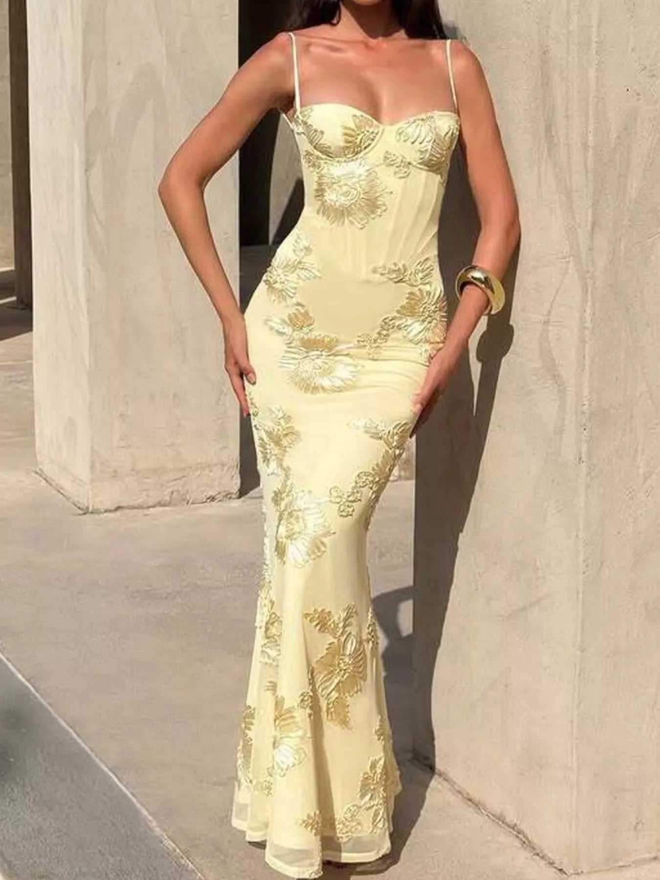 NEWYORKLISTED STYLE COLLECTION: Woman wearing a light yellow evening gown with floral embroidery against a neutral background