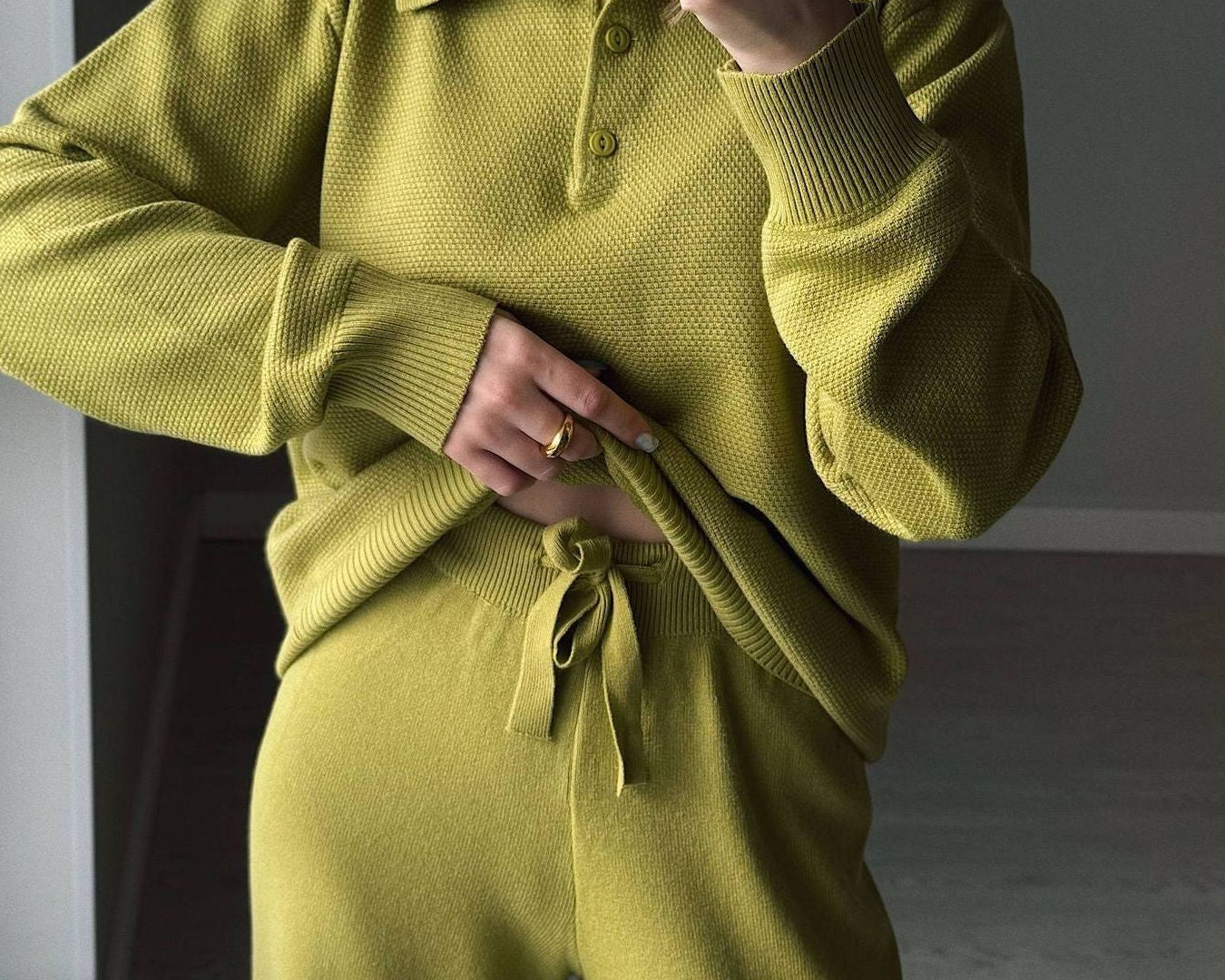 NEWYORKLISTED Comfort Collection: Person wearing a green knit outfit with a plain background