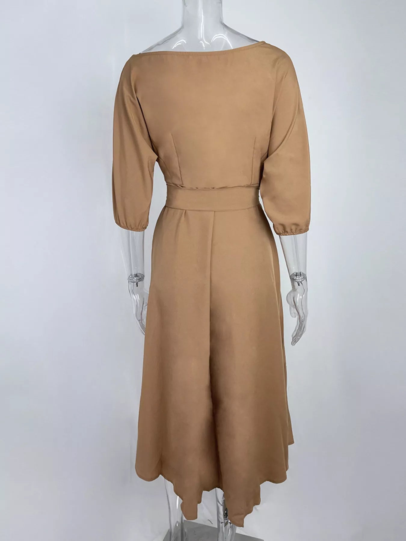 NEWYORKLISTED STYLE COLLECTION: Brown dress on a mannequin against a white background