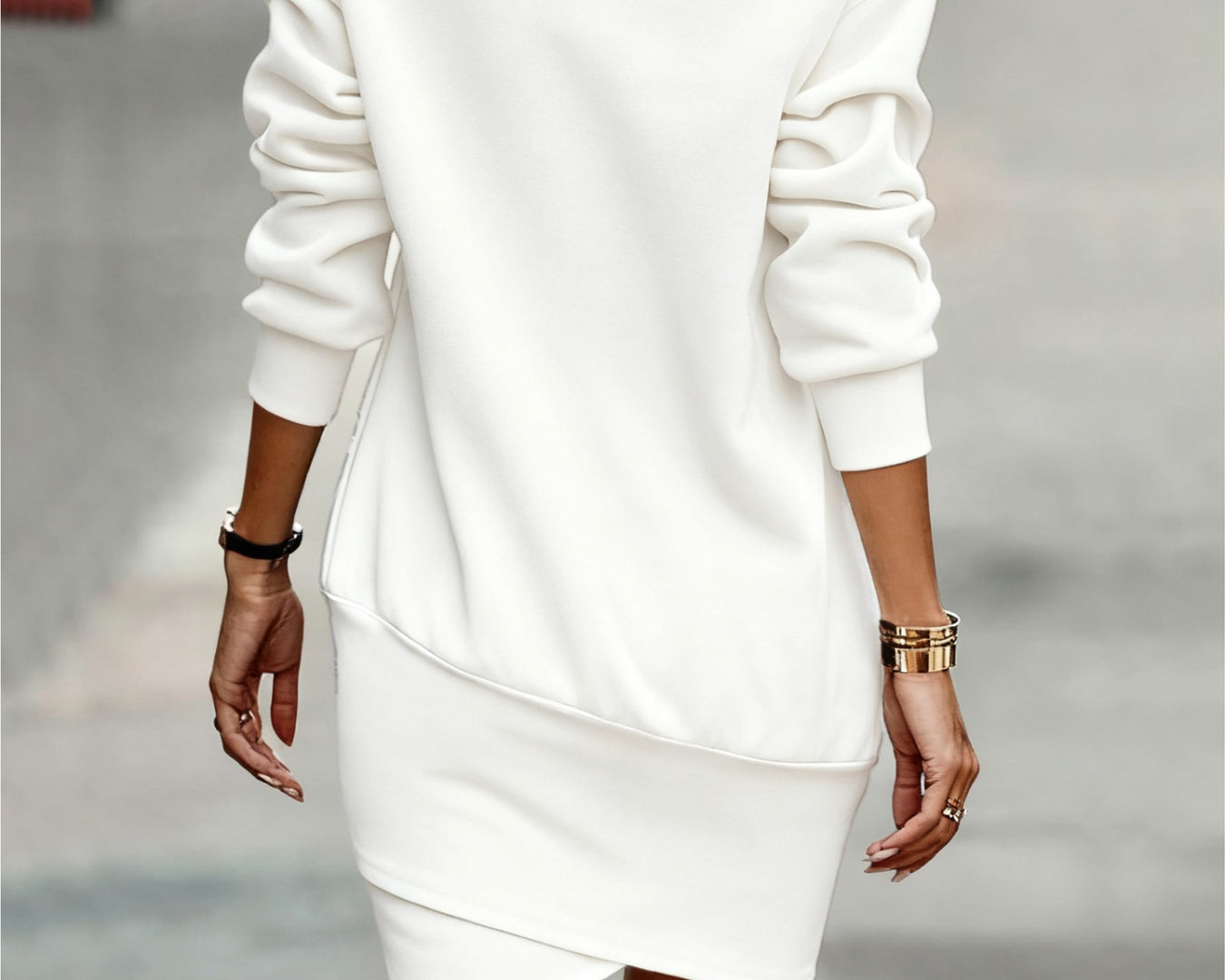 NEWYORKLISTED Style Collection: White turtleneck sweater dress worn by a person on a blurred street background